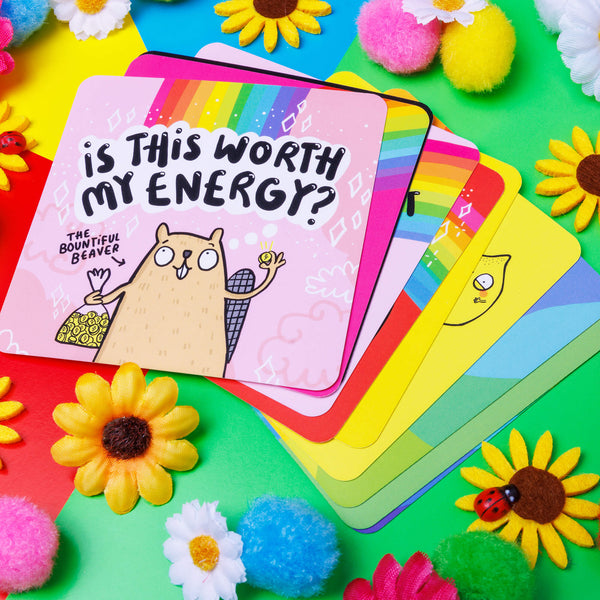 Pink square card reads 'Is this worth my energy?' in black writing featuring illustrated bountiful beaver.Happiness Enchanters Grow Your Deck, feel-good top up deck of 10 rainbow oracle cards to add to your pack. Designed and printed in the UK by Katie Abey and Angela Sandland.