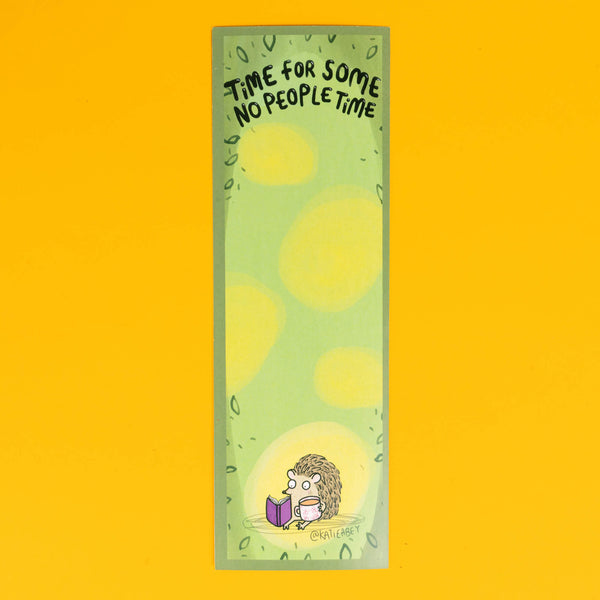 Katie Abey bookmark featuring a small, cartoon hedgehog sitting contentedly, reading a purple book. The bookmark has a soft green background with light yellow spots, and at the top, the phrase 'Time For Some No People Time' is written in playful black lettering. The design is surrounded by a subtle leafy border, perfectly capturing a peaceful, introverted moment