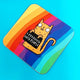 I F*ing Hate People Sweary Cat square coffee tea coaster. Rainbow background featuring orange illustrated smiley cat holding black sign. Designed by Katie Abey in the UK