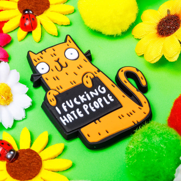 Sweary cats recycled rubber rainbow fridge magnet. Colourful orange smiley cat with black outline. Designed in the UK by Katie Abey