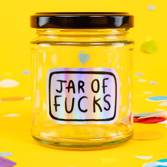 Jar of Fucks clear empty glass with shiny vinyl sticker and black lid with white writing reads 'It's oh so empty!' Designed by Katie Abey in the UK