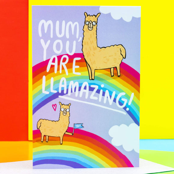 A6 Greetings Post Card Mothers Day that reads 'Mum, you are Llamazing!' with illustrated Llama's on rainbows and clouds on lavender purple background. Designed by Katie Abey in the UK