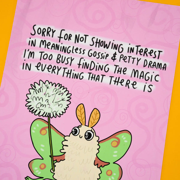 Close-up of Katie Abey art print featuring a fluffy moth with green wings holding a magic puffball. Text reads: "Sorry For Not Showing Interest In Meaningless Gossip & Petty Drama I'm Too Busy Finding The Magic In Everything That There Is." Limited A4 wall art print.