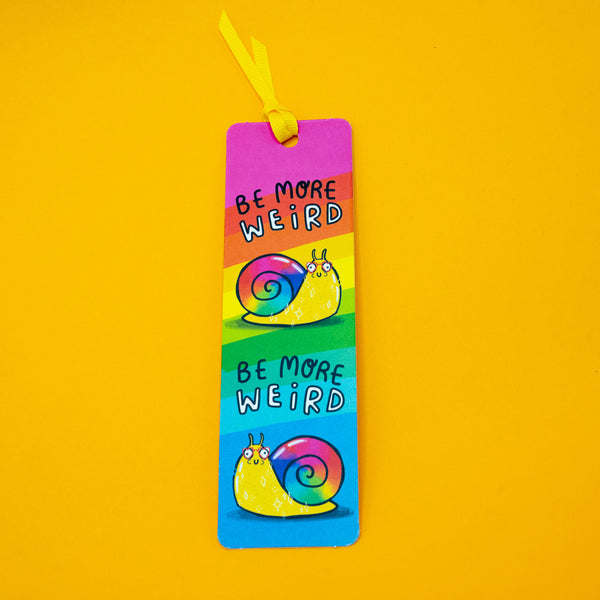 Katie Abey Be More Weird Snail Bookmark displayed on bright yellow background with vibrant rainbow stripes and smiling snail illustrations. Fun, quirky design with yellow ribbon, ideal for readers who love colourful and alternative stationery.