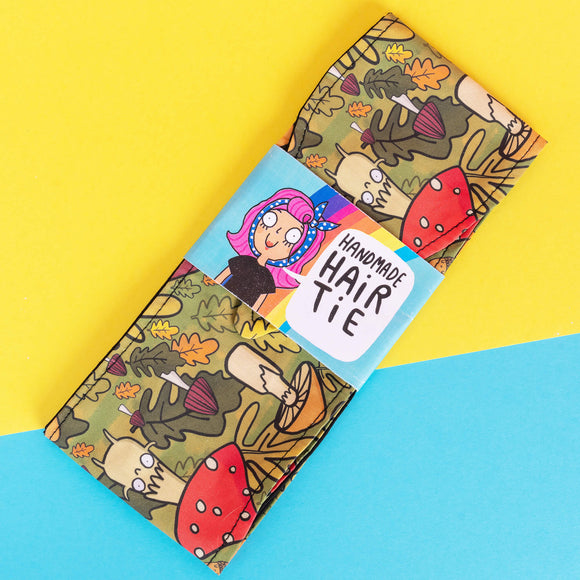 Handmade Reversible hair tie for vintage hairstyle, featuring Mushroom Bois illustration on green forest print fabric. Designed by Katie Abey X Dawny's Sewing Room in the UK