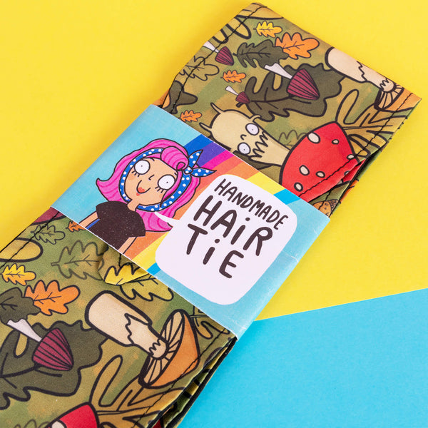 Handmade Reversible hair tie for vintage hairstyle, featuring Mushroom Bois illustration on green forest print fabric. Designed by Katie Abey X Dawny's Sewing Room in the UK