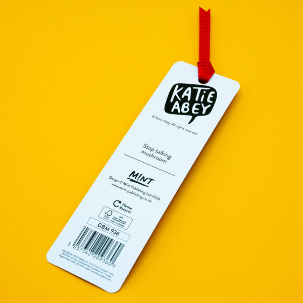 Back view of Katie Abey “Stop Talking, I’m Reading” mushroom bookmark with red ribbon tassel on yellow background. Shows brand logo, barcode and recyclable packaging details. Fun illustrated bookmark by UK artist Katie Abey, perfect quirky gift for book lovers and readers.