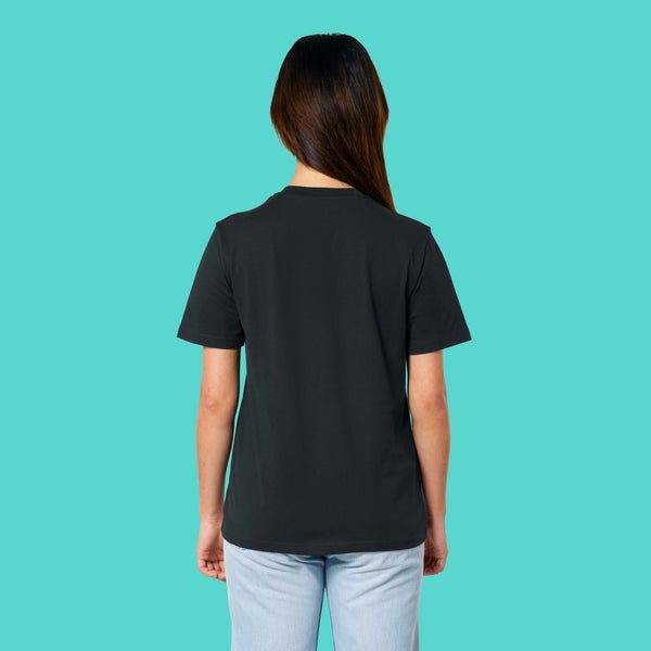Back view of a model wearing the Sweary Cat Off You F*ck Adults Tee by Katie Abey. Black unisex T shirt with a relaxed fit, short sleeves and plain back. Shown on a model against a turquoise background, highlighting the casual everyday fit of this illustrated sweary cat tee.