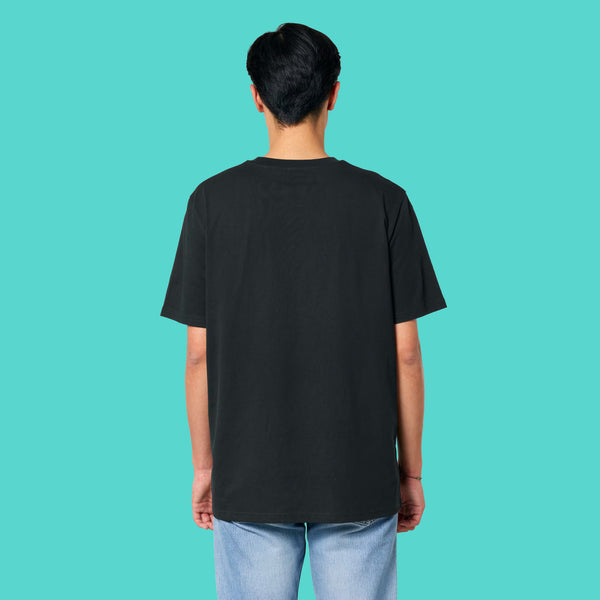 Back view of a model wearing the Sweary Cat Off You F*ck Adults Tee by Katie Abey. Black unisex T shirt styled casually with jeans. Plain back design shown clearly on a turquoise background, perfect for fans of bold, humorous and alternative illustration clothing.