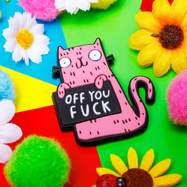 Funny sweary pink cat fridge magnet holding a black sign which reads 'off you...'. Designed by Katie Abey in the UK