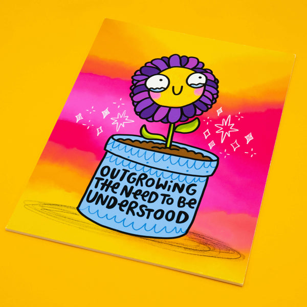 Katie Abey’s Outgrowing The Need To Be Understood art print shown on a yellow background. Features a cartoon purple flower in a pot with positive affirmation text. Fun motivational wall art, A4 matte finish, signed limited edition print, perfect for quirky home decor.