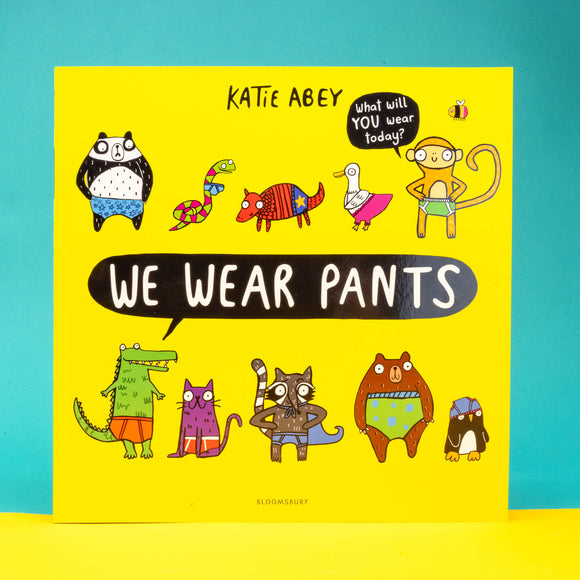 We wear pants book by Katie Abey. The book cover is yellow background with various animals wearing various pants. The centre text inside a speech bubble reads 'we wear pants' and the top right speech bubble coming off an animal reads 'what will YOU wear today'.