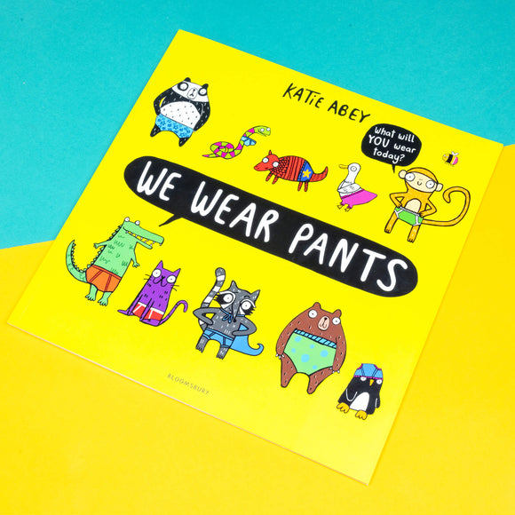 We wear pants book by Katie Abey. The book cover is yellow background with various animals wearing various pants. The centre text inside a speech bubble reads 'we wear pants' and the top right speech bubble coming off an animal reads 'what will YOU wear today'.