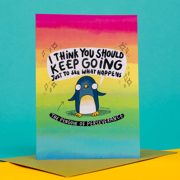 cute rainbow coloured A6 greeting card featuring The Penguin of Perseverance with a smile on it's face and speech bubble above that reads 'I think you should keep going just to see what happens'. The card comes with a gold envelope. Designed by Katie Abey.