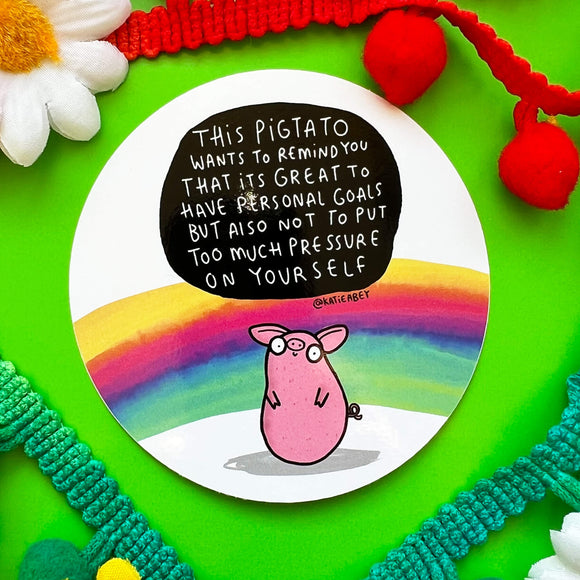 A white based sticker of a pig shaped like a potato with text saying this pigtail wants to remind you that its great to have personal goals but also not to put too much pressure on yourself.