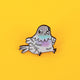 Katie Abey’s pigeon enamel pin displayed against a yellow background. The pin features a chubby pastel pigeon with adorable, quirky details, perfect for pin lovers and fans of playful accessories. A small business gem with personality!