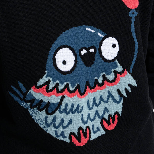 Detailed close up of the large pigeon with red balloon design on the back of the Katie Abey x Rebel Romance Pigeon Party Long Cardigan. Soft black knit with bold red accents, quirky bird illustration and playful alternative fashion style.
