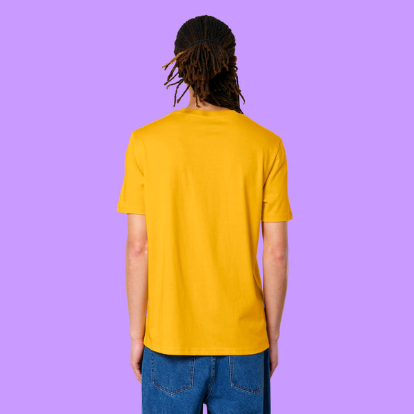 Back view of a Spectra Yellow Katie Abey Prioritising Whimsy, Nonsense and Joy adults t-shirt worn by a model with dreadlocks. The organic cotton unisex tee shows a relaxed fit and plain back against a purple background.