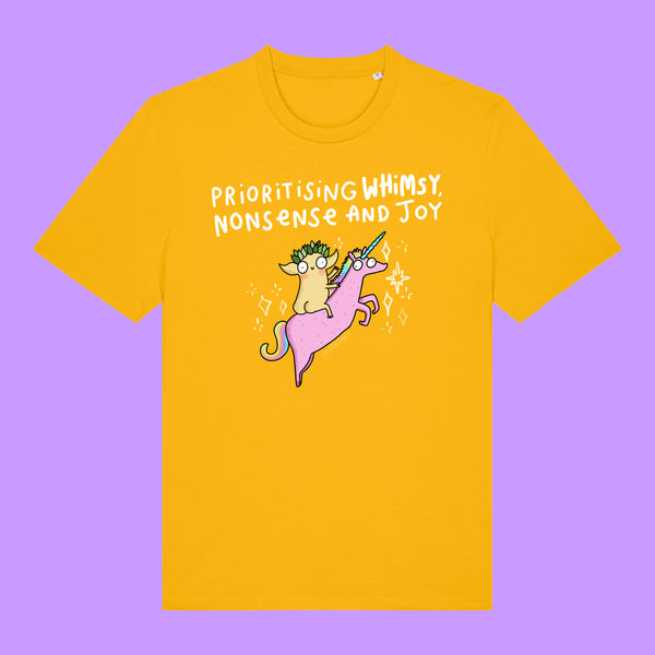 Front view of a Spectra Yellow Katie Abey Prioritising Whimsy, Nonsense and Joy adults graphic t-shirt. The organic cotton tee features a whimsical illustration of a quirky character riding a pink unicorn with playful typography.