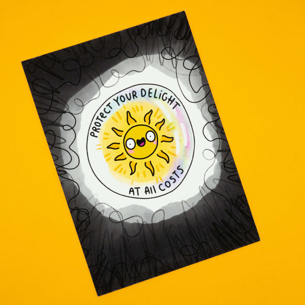 Katie Abey A4 sunshine art print with the phrase “Protect Your Delight At All Costs”. Features a bold, quirky design with a happy sunshine character. Matte finish print mounted on foam-backed board, signed and numbered by the illustrator. Limited edition of 10, ideal for alternative home décor or a cheerful gift.