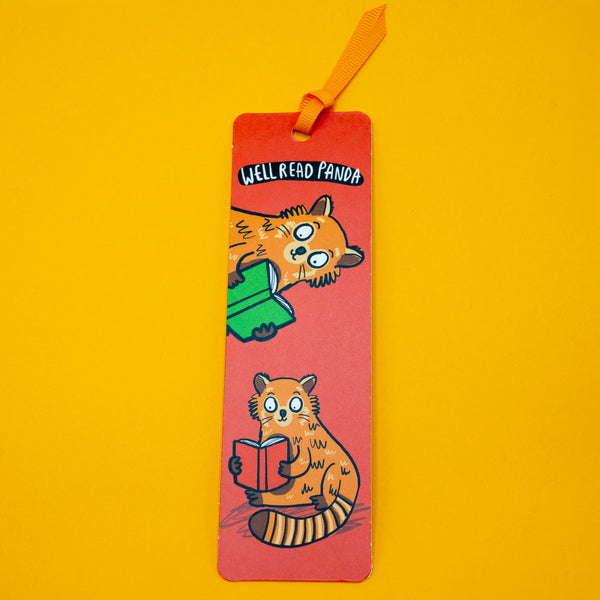 Full view of Katie Abey Well Read Panda Red Panda Bookmark with orange ribbon on yellow background. Cute illustrated red pandas reading books with playful design, ideal for book lovers, gifts and quirky stationery fans.