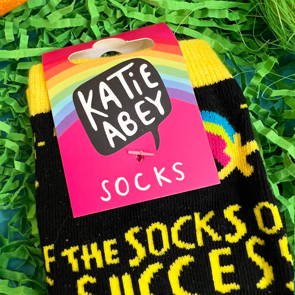 close up of the Katie Abey pink tag attached to the socks