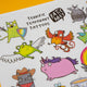 Close up of Katie Abey Terrific Temporary Tattoos sheet showing detailed cartoon illustrations including a flying frog, phoenix bird and unicorn, with bold outlines and vibrant colours on a white background.
