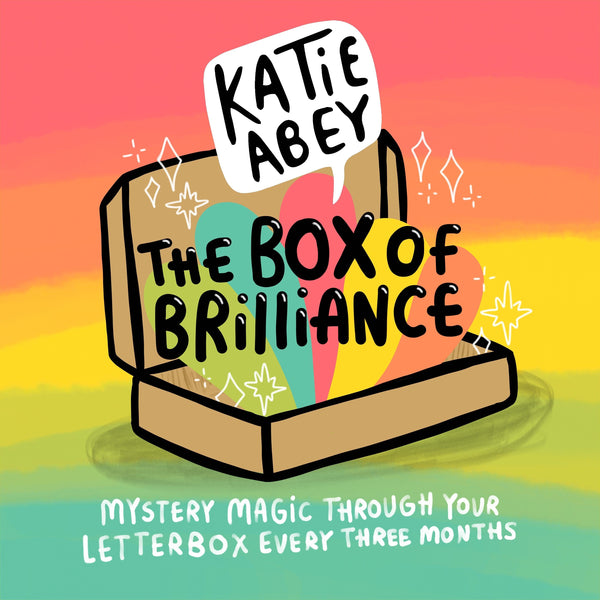 The Katie Abey box of brilliance subscription mystery box. Illustrated brown cardboard box sat open on a rainbow background with rainbows and white sparkles bursting out and text reading 'the box of brilliance' with the Katie Abey logo. Bottom text reads 'Mystery magic through your letterbox every three months'.