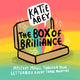 The Katie Abey box of brilliance subscription mystery box. Illustrated brown cardboard box sat open on a rainbow background with rainbows and white sparkles bursting out and text reading 'the box of brilliance' with the Katie Abey logo. Bottom text reads 'Mystery magic through your letterbox every three months'.