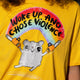 Close up of the Katie Abey Woke Up and Chose Violence Hamster Adults Tee in Spectra Yellow. The bold graphic features a cute grey hamster holding chainsaws beneath a rainbow with the slogan Woke Up and Chose Violence. Bright, playful illustration printed on a yellow unisex t shirt by UK illustrator Katie Abey.
