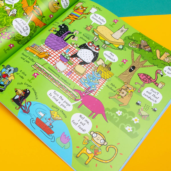 We Eat Bananas book by Katie Abey laying open flat on . The brightly coloured page spread features various animals at a picnic discussing various foods. 