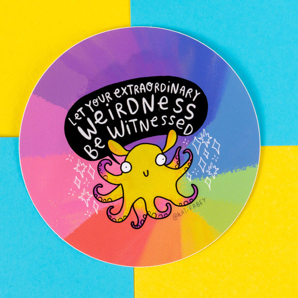 A bright sticker by Katie Abey showcasing a cheerful yellow octopus character with playful tentacles, set against a rainbow-coloured backdrop. The bold text says, "Let your extraordinary weirdness be witnessed." The artwork promotes self-expression and creativity, perfectly embodying Katie Abey's quirky and uplifting style. Positioned on a vibrant blue and yellow background, this sticker is a fun addition for anyone embracing their inner weirdness.