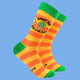 Bright orange and yellow striped socks with green accents featuring a quirky design by Katie Abey. The socks display a cheeky succulent in a pink pot with glasses and the text "What the Fucculent?" A fun, weird, and illustrated gift idea.