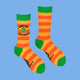 Katie Abey's vibrant "What the Fucculent?" socks, featuring bold orange and yellow stripes with a succulent design. Fun green toes and cuffs complete these plant-themed socks, ideal for adding a pop of personality to your wardrobe.