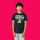 Child wearing black Wield Your Weird kids t shirt by Katie Abey, featuring colourful cartoon artwork and bold text. Short sleeve organic cotton tee with a comfy relaxed fit, photographed on a bright pink background. Fun unisex kids clothing designed to celebrate creativity and individuality.