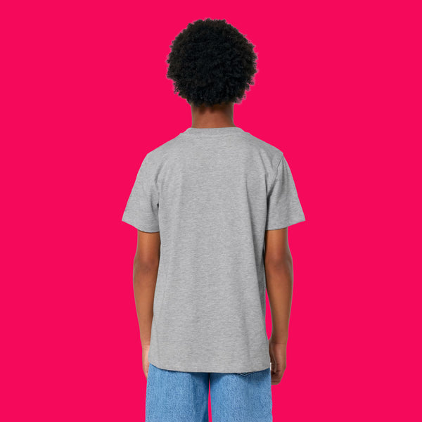 Back view of child wearing heather grey kids t shirt by Katie Abey, showing a plain back, short sleeves and relaxed fit. Organic cotton unisex children’s tee photographed on a bright pink background, designed for comfort, play and everyday adventures.