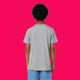 Back view of child wearing heather grey kids t shirt by Katie Abey, showing a plain back, short sleeves and relaxed fit. Organic cotton unisex children’s tee photographed on a bright pink background, designed for comfort, play and everyday adventures.