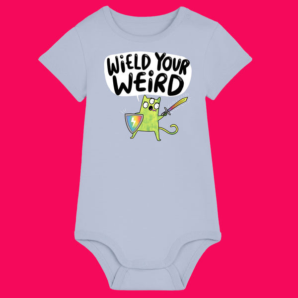 Serene Blue Wield Your Weird baby grow by Katie Abey, featuring a colourful illustrated character holding a sword and shield with the slogan “Wield Your Weird” on the front. Short sleeved unisex baby grow with popper fastenings, made for comfort while celebrating individuality, creativity and being proudly weird.