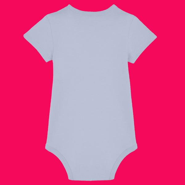 Serene Blue baby grow shown from the back, featuring a plain design with short sleeves and popper fastenings at the bottom. This unisex baby grow has a soft, smooth finish and a comfortable fit, ideal for everyday wear. Designed by Katie Abey, a small UK illustrator known for encouraging creativity and embracing being weird.