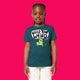 Child wearing stargazer blue Wield Your Weird kids t shirt by Katie Abey, featuring colourful cartoon artwork and bold text. Organic cotton unisex children’s tee with a comfy fit, photographed on a bright pink background.