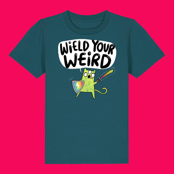 Stargazer blue kids t shirt featuring Katie Abey Wield Your Weird artwork with a green cartoon character, rainbow shield and sword. Organic cotton children’s tee on a bright pink background, bold colourful illustration celebrating creativity and individuality.