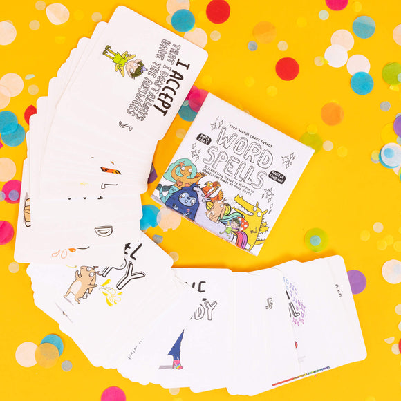 Box of Word Spell Cards on a yellow background with confetti. the box is white with 'your words carry energy' and 'affirmation cards to help you to harness the power of your voice' written on with various illustrations. Theres lots of cards laid out in a fan