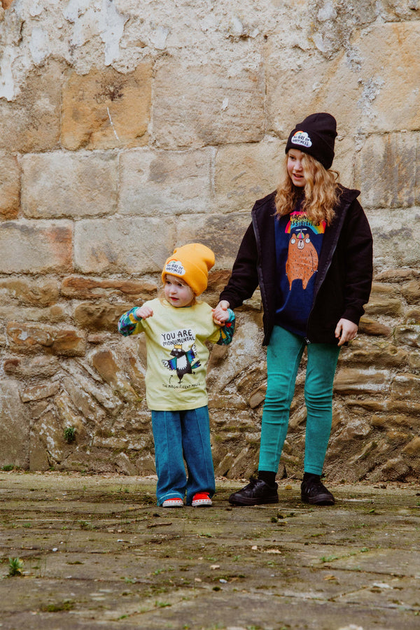 Monumental Magpie Yellow Kids Tshirt 100% cotton tshirt with illustrated happy magpie design wearing crown with speech bubble and black writing that reads 'The Magnificent Magpie'. Designed in the UK by Katie Abey