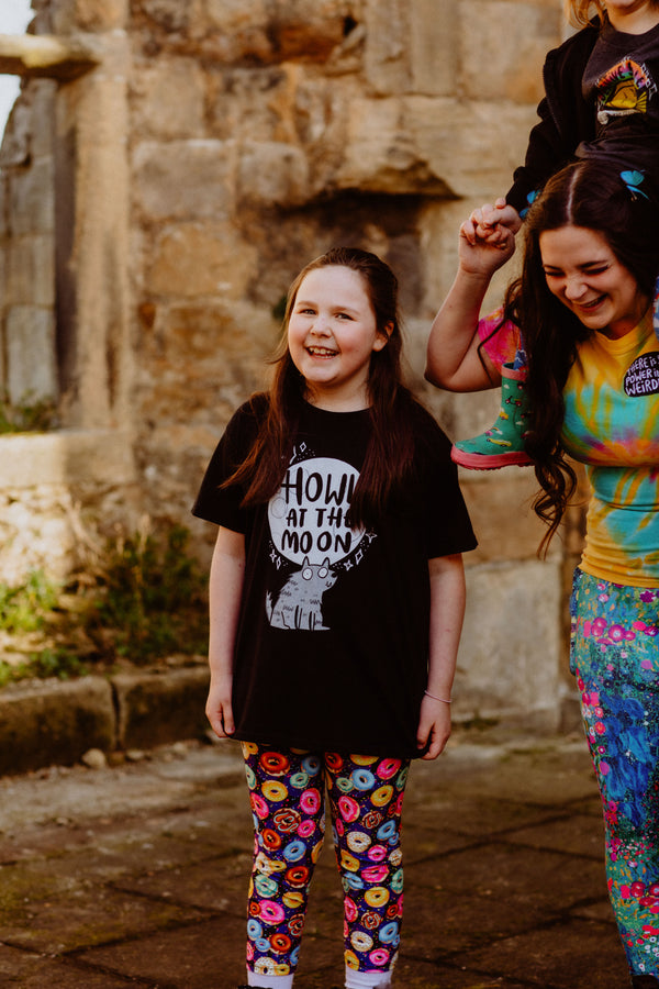 Howl at the Moon youth kids childrens black T-shirt with illustrated smiley wolf and moon. 100 % cotton. Designed by Katie Abey in the UK.