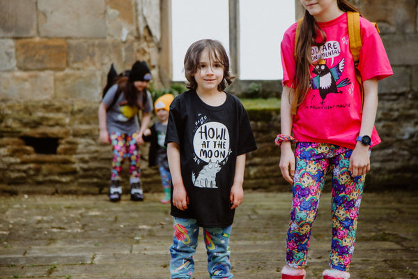 Howl at the Moon youth kids childrens black T-shirt with illustrated smiley wolf and moon. 100 % cotton. Designed by Katie Abey in the UK.