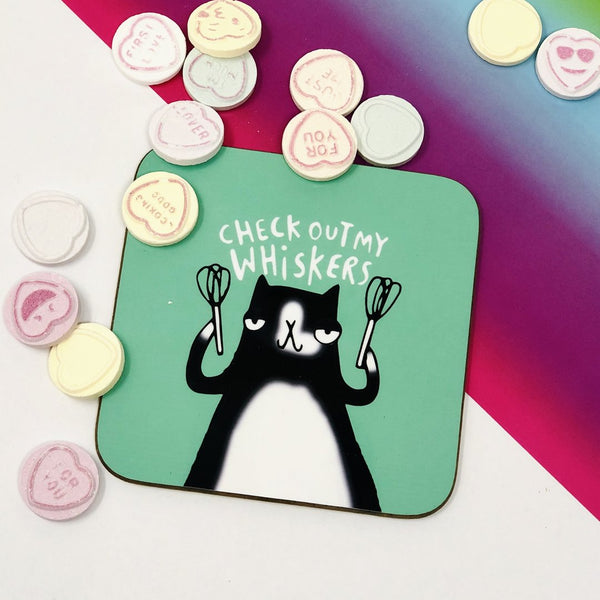 Check out my whiskers cat tea coffee coaster. Black and white cat holding whisks on green teal background. Designed by Katie Abey in the UK