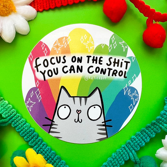 Focus on the things you can control circular vinyl sticker featuring a smiley illustrated cat on rainbow colours and stars. Designed in the UK by Katie Abey