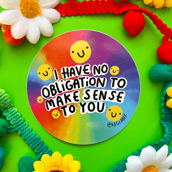 I have no obligation to make sense to you sticker, circular vinyl sticker with rainbow watercolour effect background featuring yellow smiley faces and black and white writing. Designed by Katie Abye in the UK 