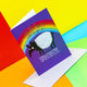 An A6 greetings card on a purple and rainbow background. It featured a tapir illustration by Katie Abey and has 'YOU ARE AS TERRIFIC AS A TAPIR!' underneath the illustration it says '(which is pretty much the most terrific you can be so well done) it is sat on its envelope against a red and yellow background.